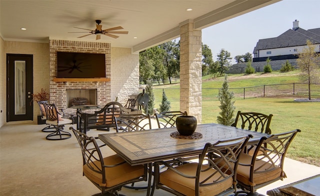 view of patio / terrace with ceiling fan and an outdoor brick fireplace