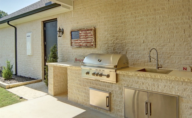 view of patio featuring area for grilling and sink