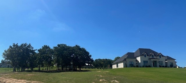 view of side of home with a yard