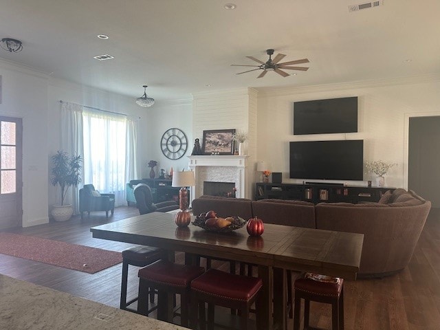 dining space with ceiling fan, hardwood / wood-style floors, and crown molding