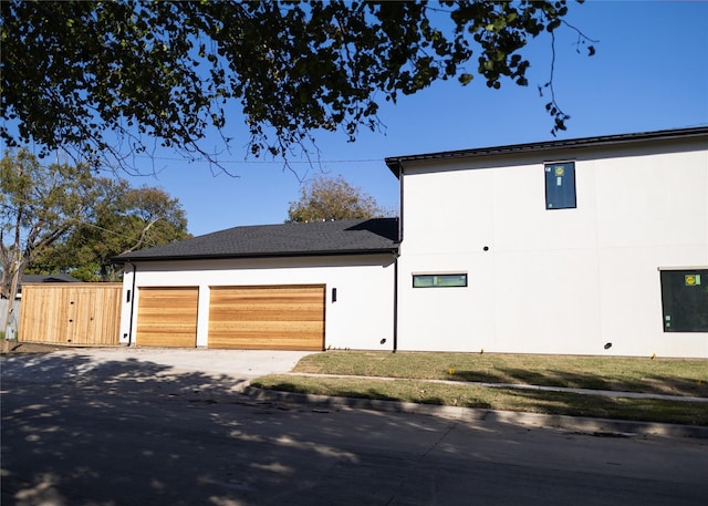 view of home's exterior with a lawn and a garage