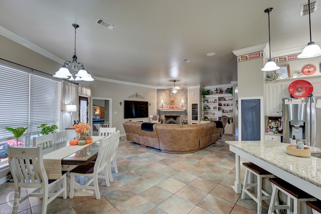 interior space with a fireplace, an inviting chandelier, and ornamental molding