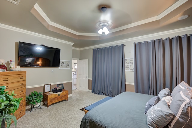 carpeted bedroom with ornamental molding, a raised ceiling, and ceiling fan