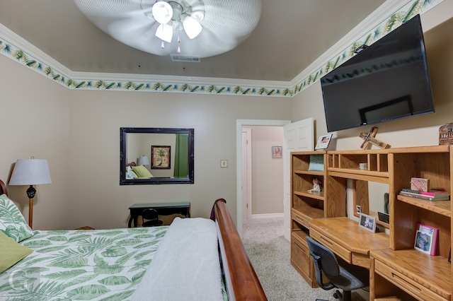 carpeted bedroom with ceiling fan and ornamental molding