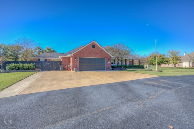 ranch-style house with a garage and a front lawn