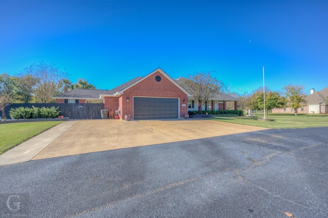 single story home with a garage and a front lawn