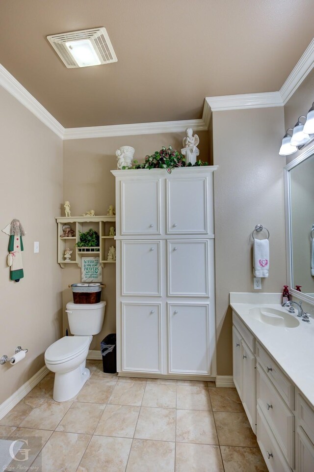 bathroom with tile patterned floors, crown molding, vanity, and toilet