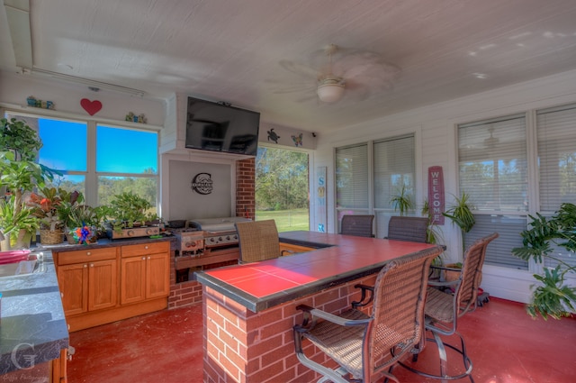 home office with ceiling fan, concrete flooring, and sink