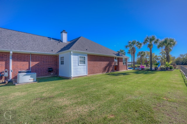 back of property featuring a lawn