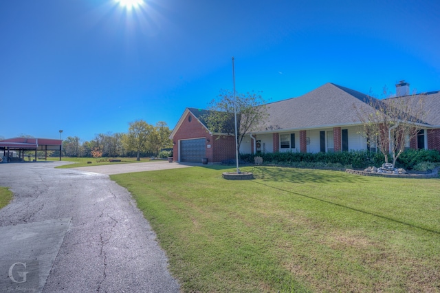 ranch-style home with a front lawn and a garage