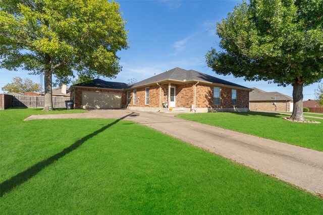 ranch-style house featuring a garage and a front lawn