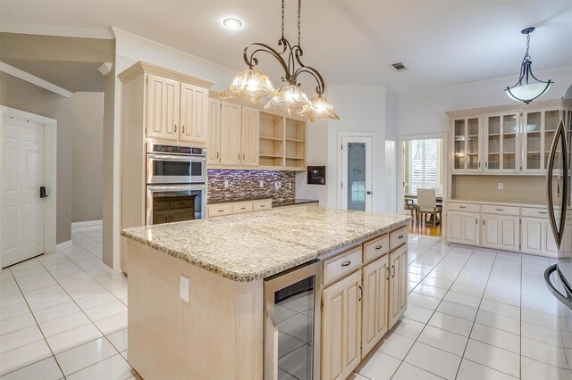 kitchen featuring tasteful backsplash, stainless steel appliances, crown molding, a kitchen island, and hanging light fixtures