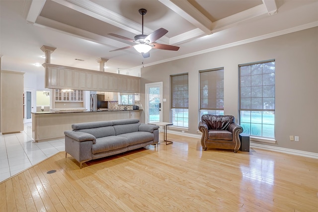 living room with coffered ceiling, ceiling fan, crown molding, beam ceiling, and light hardwood / wood-style floors