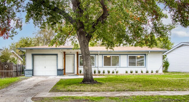 ranch-style house featuring a front lawn and a garage