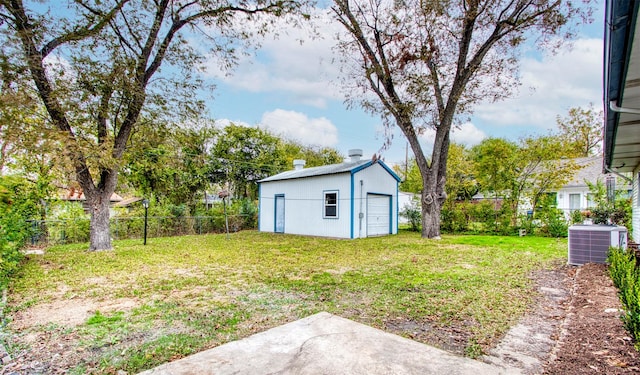 view of yard with central AC and an outdoor structure