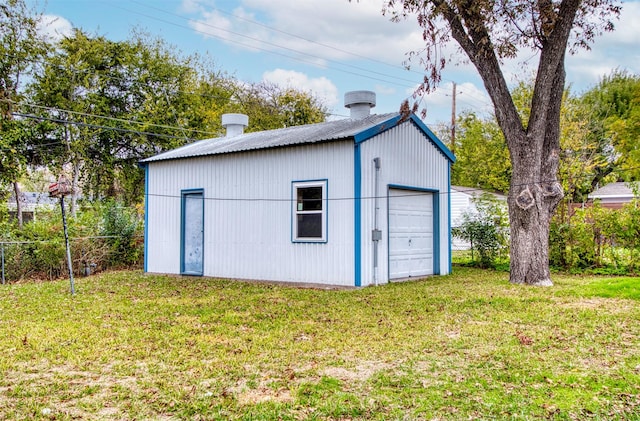 view of outbuilding featuring a garage and a yard