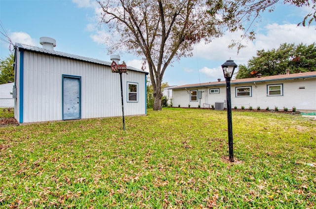 view of yard featuring an outbuilding and central air condition unit