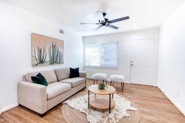 living room featuring ceiling fan and light wood-type flooring