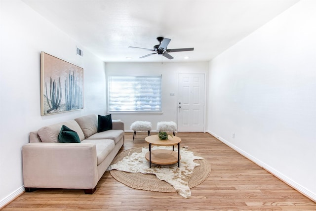 living room with ceiling fan and light wood-type flooring