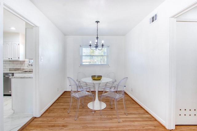 dining room featuring a notable chandelier