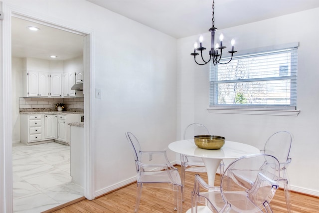 dining area with an inviting chandelier