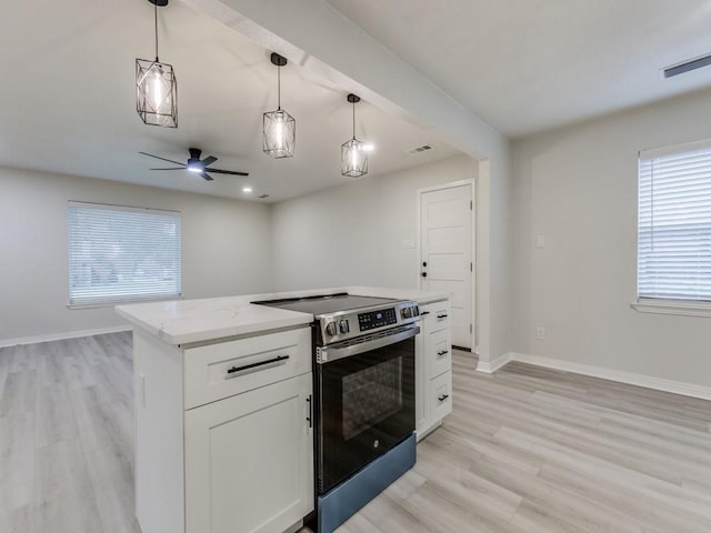 kitchen featuring light wood-style floors, stainless steel electric stove, baseboards, and visible vents