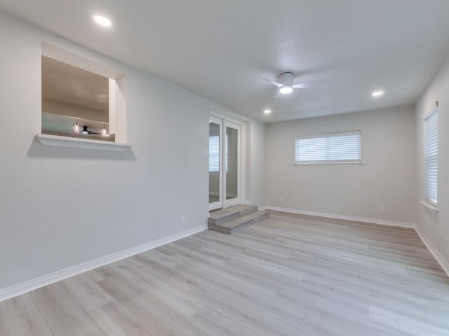 spare room featuring light hardwood / wood-style flooring and ceiling fan