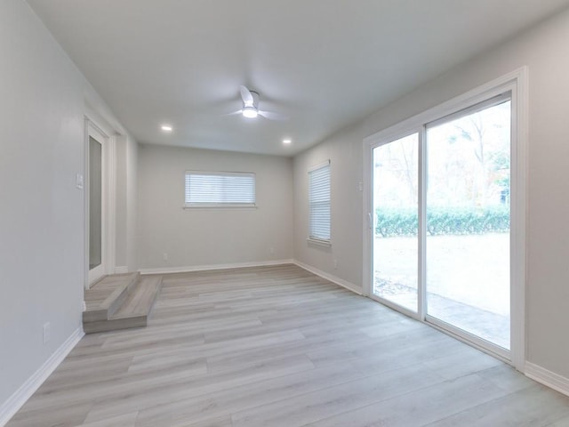 empty room with recessed lighting, baseboards, light wood finished floors, and ceiling fan