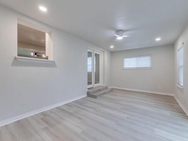 empty room featuring ceiling fan and light hardwood / wood-style flooring