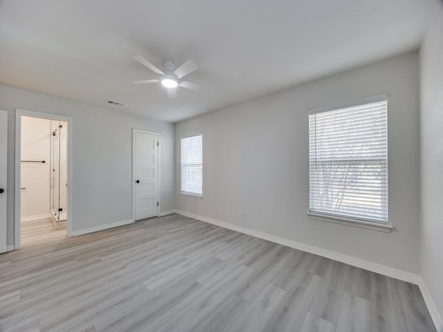 unfurnished room featuring visible vents, baseboards, light wood-style flooring, and a ceiling fan