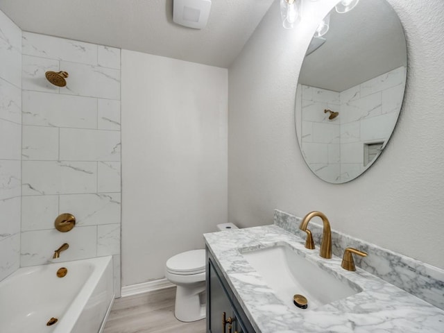 full bathroom with toilet, vanity, shower / bathtub combination, wood finished floors, and a textured ceiling