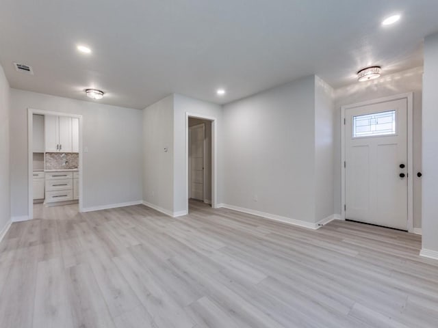 entryway with recessed lighting, light wood-type flooring, baseboards, and visible vents