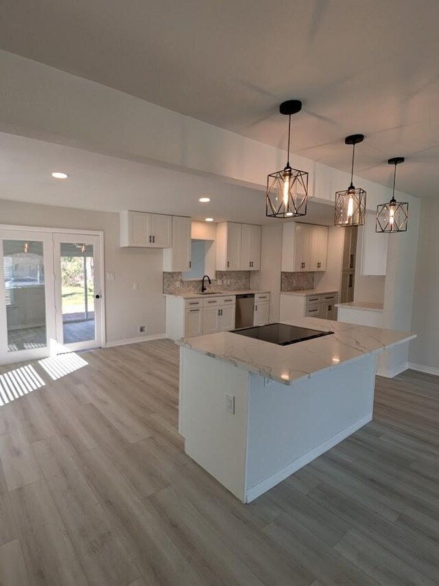 kitchen featuring electric range, ceiling fan, decorative light fixtures, light hardwood / wood-style floors, and white cabinetry