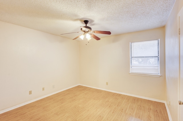 spare room featuring a textured ceiling, light hardwood / wood-style flooring, and ceiling fan