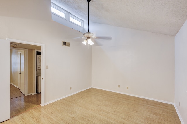 unfurnished room featuring ceiling fan, lofted ceiling, a textured ceiling, and light hardwood / wood-style flooring