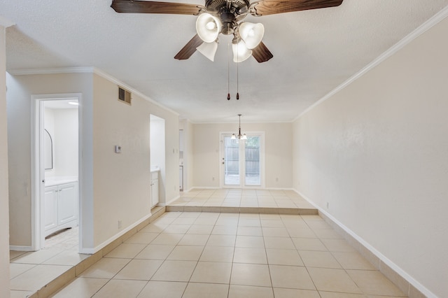 spare room with crown molding, ceiling fan with notable chandelier, a textured ceiling, and light tile patterned floors