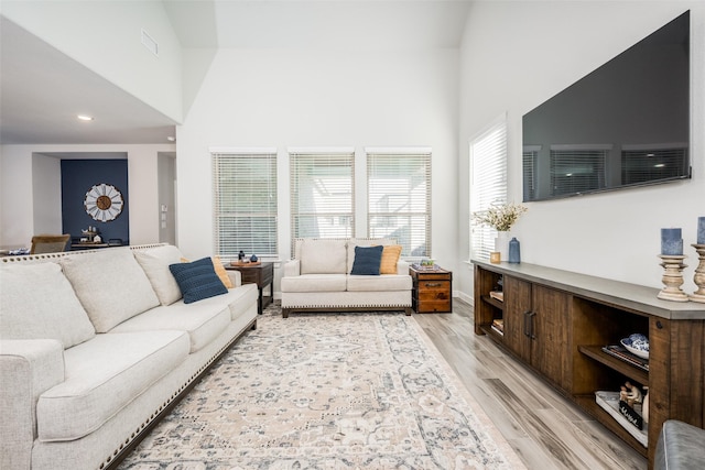 712 8th St, Argyle, TX 76226 - living room with light wood-type flooring, a towering ceiling, and recessed lighting