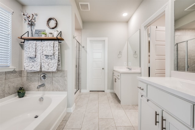 bathroom with separate shower and tub and vanity