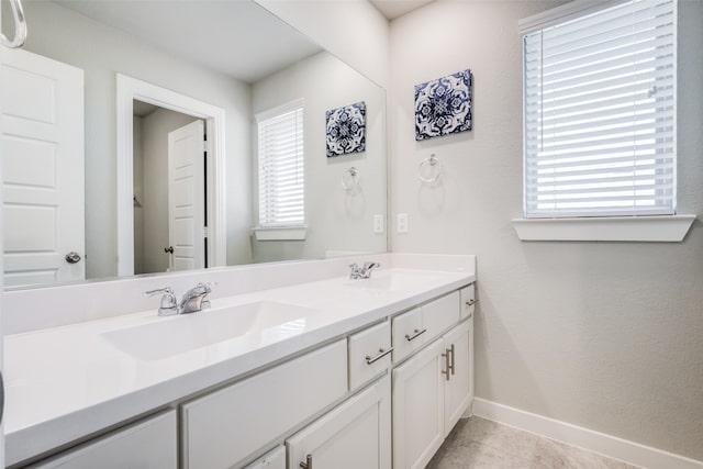 bathroom with tile patterned flooring and vanity