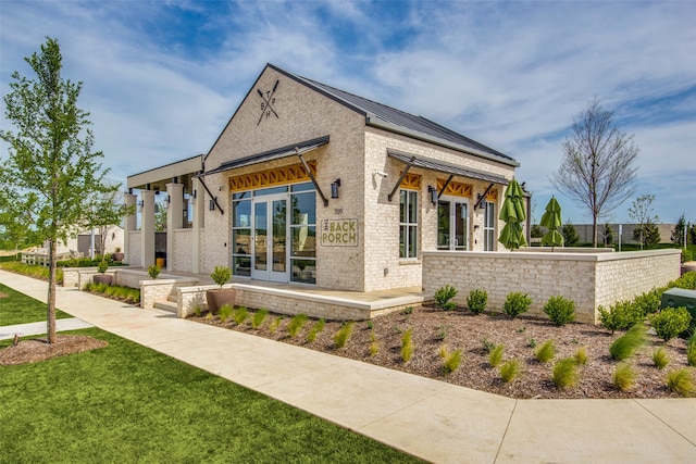 exterior space with a yard and french doors