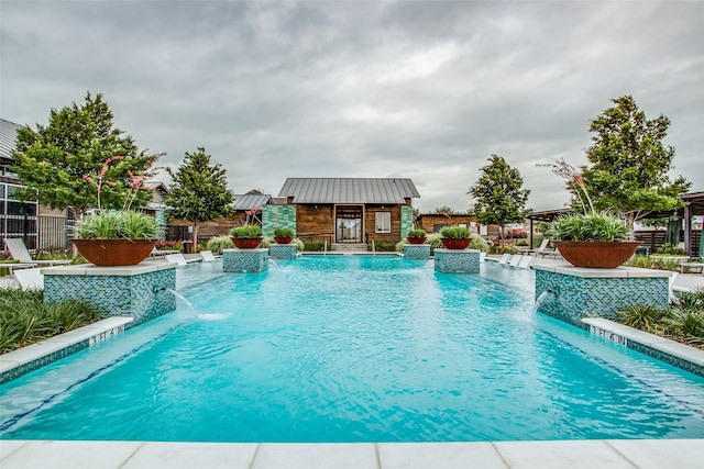 view of swimming pool with pool water feature