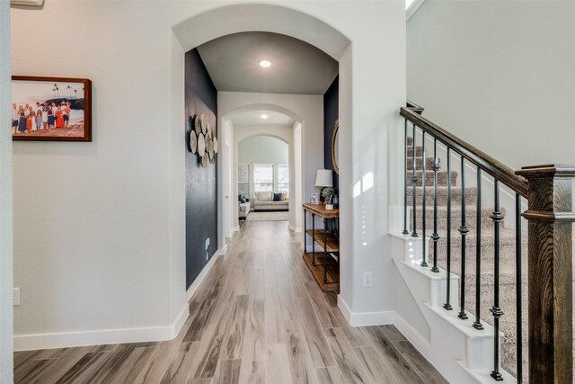 712 8th St, Argyle, TX 76226 - corridor with arched walkways, wood finished floors, stairs, and baseboards