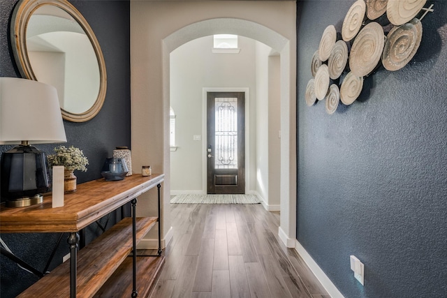 712 8th St, Argyle, TX 76226 - foyer entrance featuring arched walkways, dark wood-style floors, baseboards, and a textured wall