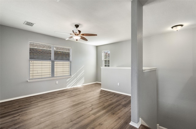 empty room featuring dark hardwood / wood-style floors and ceiling fan