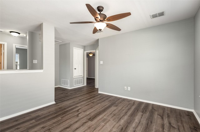 spare room with ceiling fan and dark hardwood / wood-style flooring