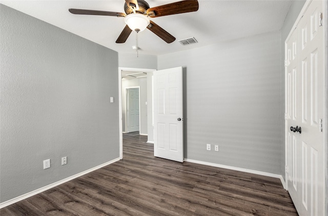 unfurnished bedroom with dark hardwood / wood-style floors and ceiling fan