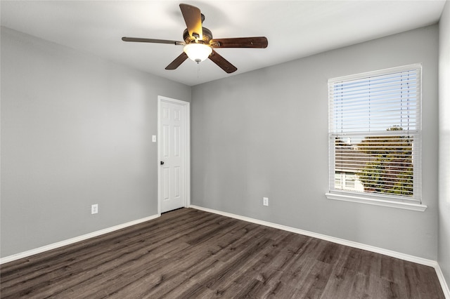 empty room featuring ceiling fan and dark hardwood / wood-style floors