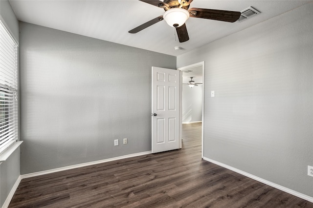 spare room featuring dark hardwood / wood-style floors and ceiling fan