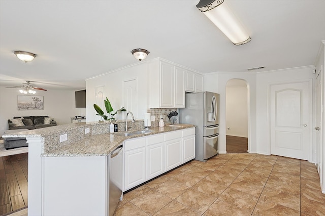 kitchen featuring ceiling fan, sink, stainless steel appliances, crown molding, and white cabinets