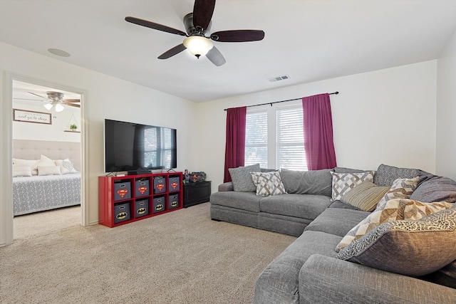 living room with ceiling fan and light colored carpet